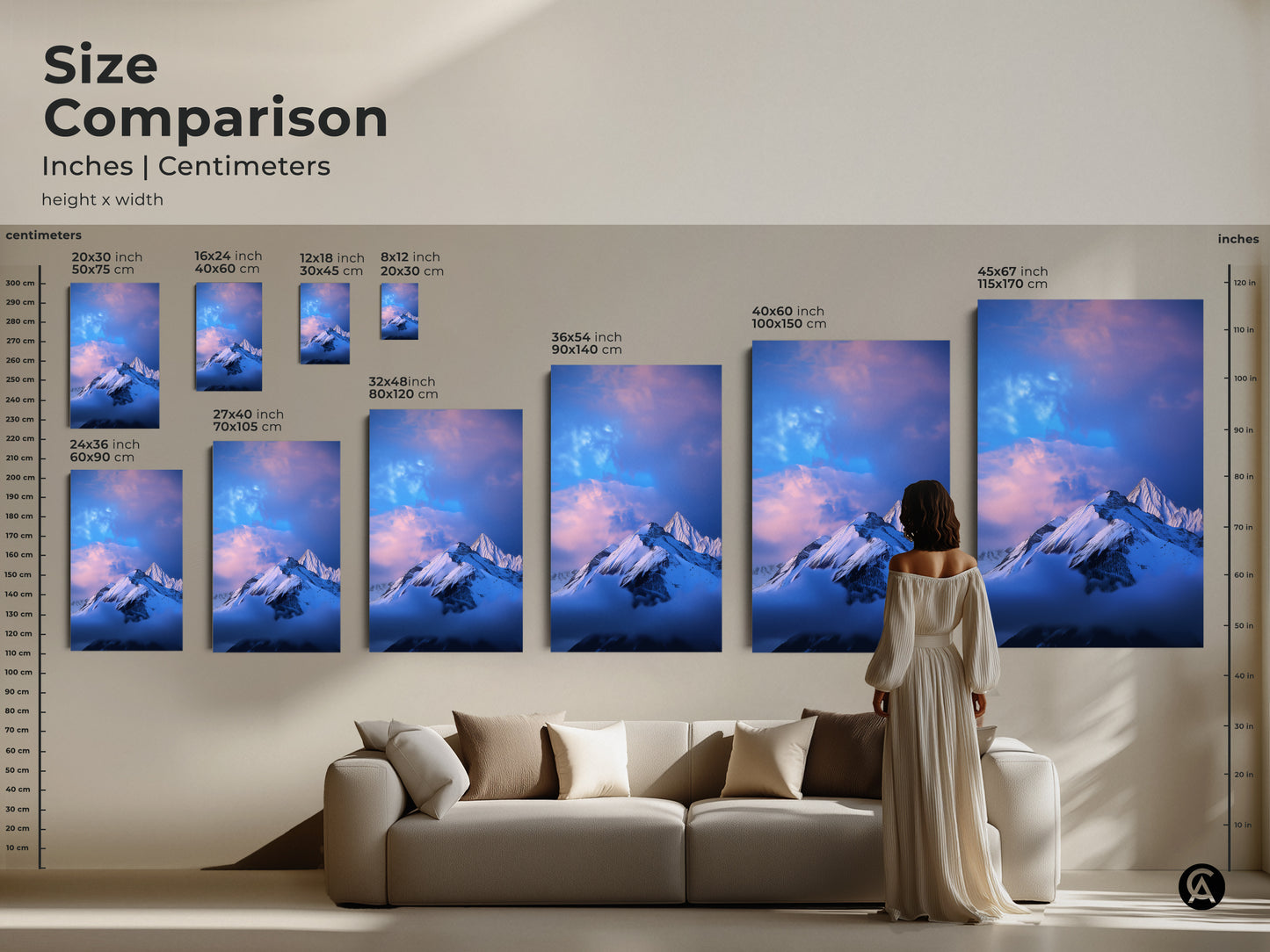 Size comparison of snowy mountain artwork in inches and centimeters. See the different sizes next to a sofa and a person. This blue and white art is great for any room. Find the perfect fit for your space today.
