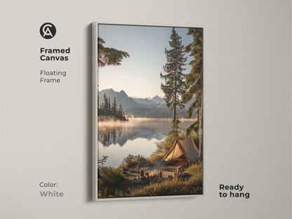 Framed canvas in white showcasing mountain lake camping art. The floating frame highlights this outdoor adventure wall decor. It features a rustic tent canvas print. Ready to hang this nature landscape brings a cozy cabin art atmosphere. This serene lake view print is ideal as a housewarming gift.