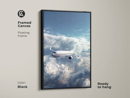 Framed canvas of an airplane flying through clouds. This aviation artwork has a black floating frame and is ready to hang. It is a modern sky blue airplane print. Perfect for office decor or a travel gift.