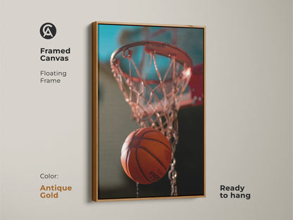This is framed canvas basketball net art. This action shot basketball print has a floating frame. The antique gold frame is ready to hang. The orange and teal artwork is a versatile wall decor piece. It's a great gift for hoop fans.