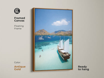 An antique gold frame enhances this aerial ocean artwork. The turquoise waters glisten in this coastal landscape. It's ideal beach house decor ready to hang. This tropical island artwork features sailboats in paradise. Perfect for adding a touch of maritime charm to any room.