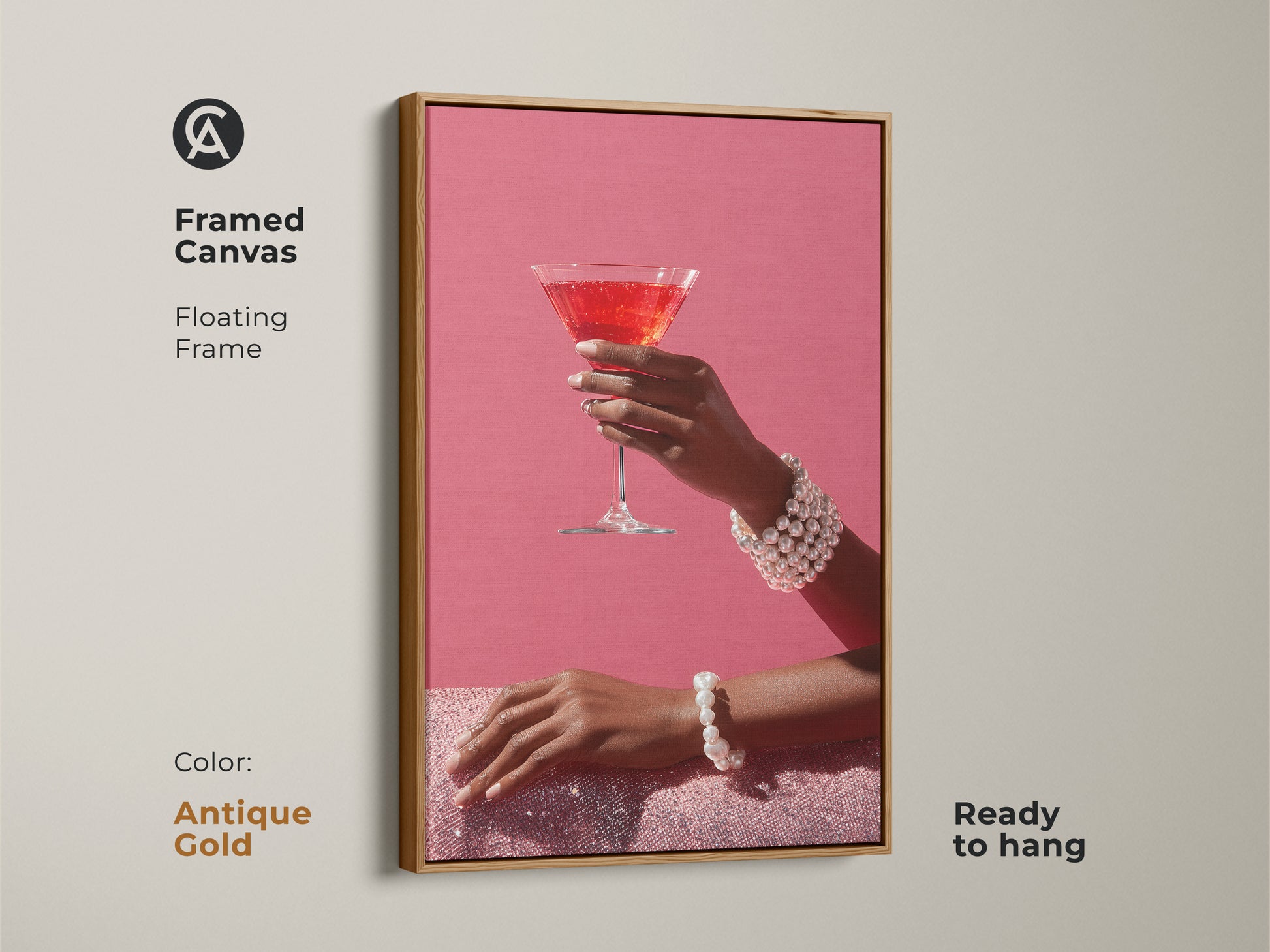 This framed canvas features chic pink martini art with an antique gold floating frame. The artwork displays a hand with a pearl bracelet. This contemporary cocktail decor is ready to hang. Perfect for adding a touch of luxury to your bar area. The ultimate glam bar wall art.