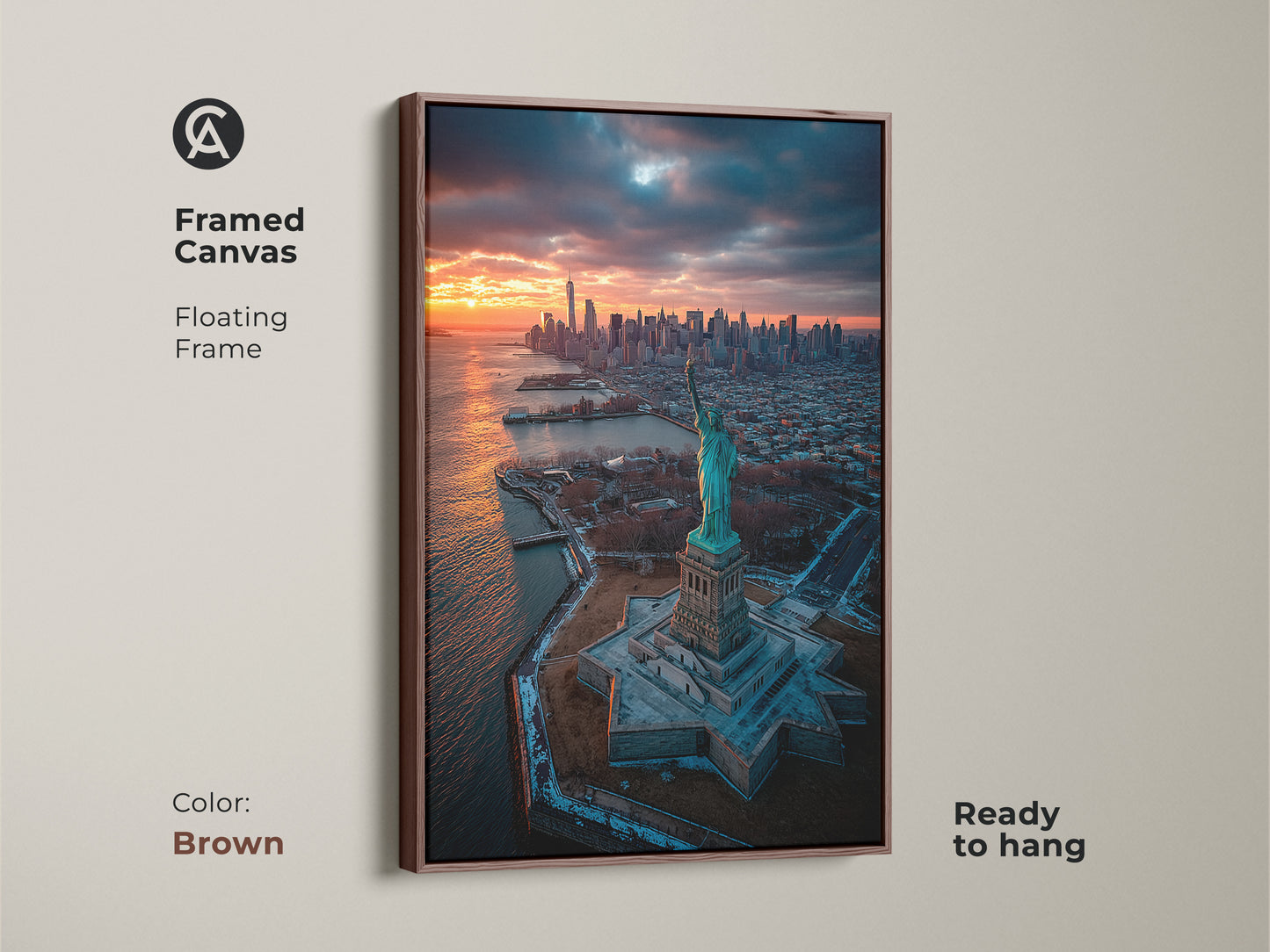 This framed canvas features the Statue of Liberty and NYC during sunset. The floating frame in brown complements the artwork. This piece is ready to hang and brings a warm touch. Ideal for traditional interiors.