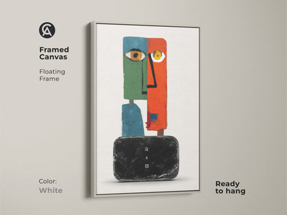 Framed canvas of a modern abstract face artwork with a floating white frame. This surreal wall decor features an eclectic orange green and teal color palette. The figurative geometric canvas art is ready to hang. A perfect addition to a bedroom or living room. This contemporary wall art adds sophistication to any space.