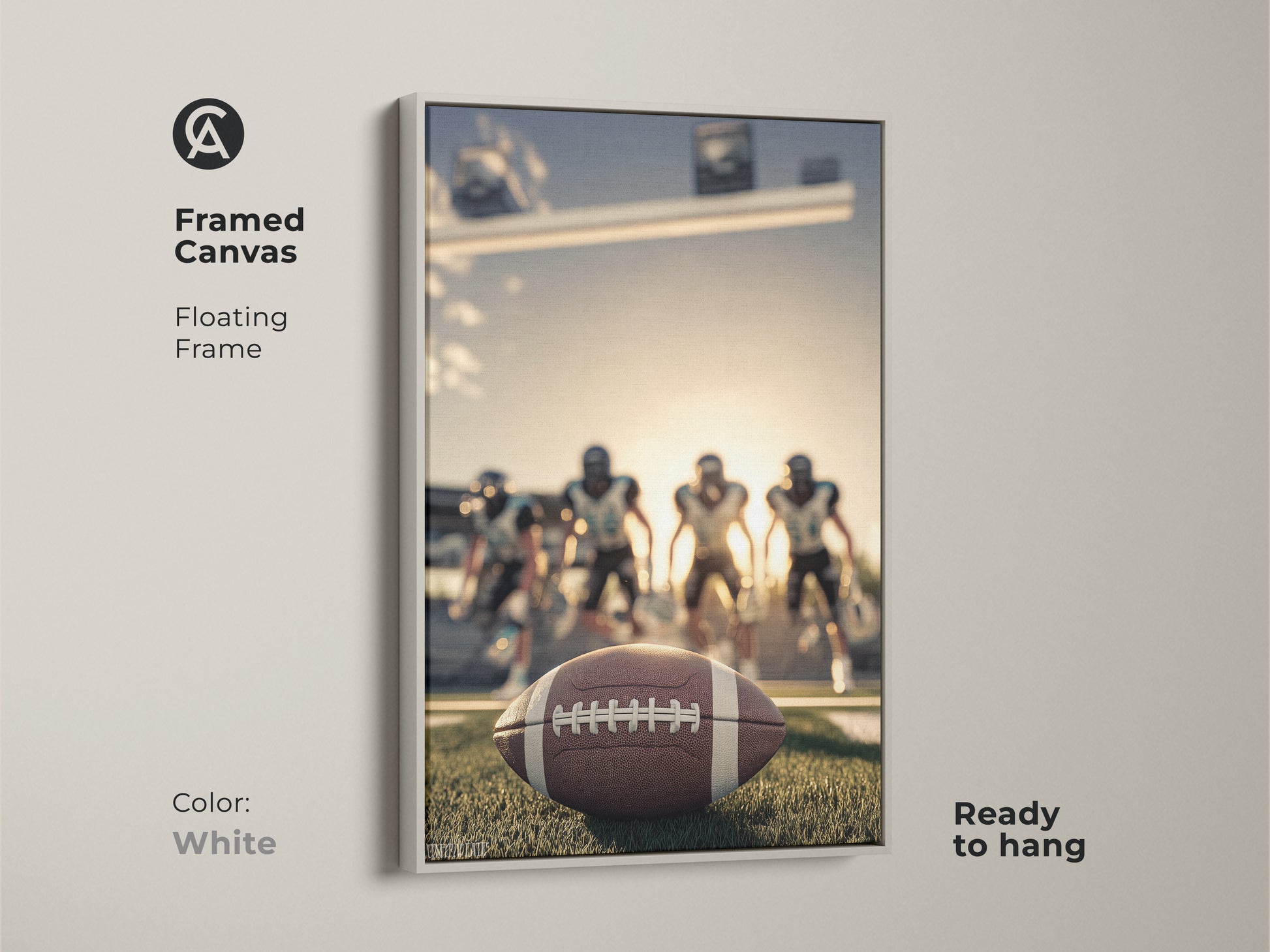 American Football artwork with a white floating frame. The framed canvas is ready to hang. It features a football close-up on the field. Players are in the background. This sports action photography makes a great Father's Day sports gift.