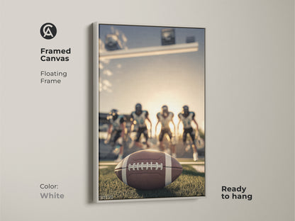 American Football artwork with a white floating frame. The framed canvas is ready to hang. It features a football close-up on the field. Players are in the background. This sports action photography makes a great Father's Day sports gift.