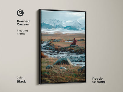Black framed canvas art featuring a serene mountain scene. A lone monk is meditating by a stream. This floating frame is ready to hang. Add a touch of zen to your decor with this framed spiritual artwork.