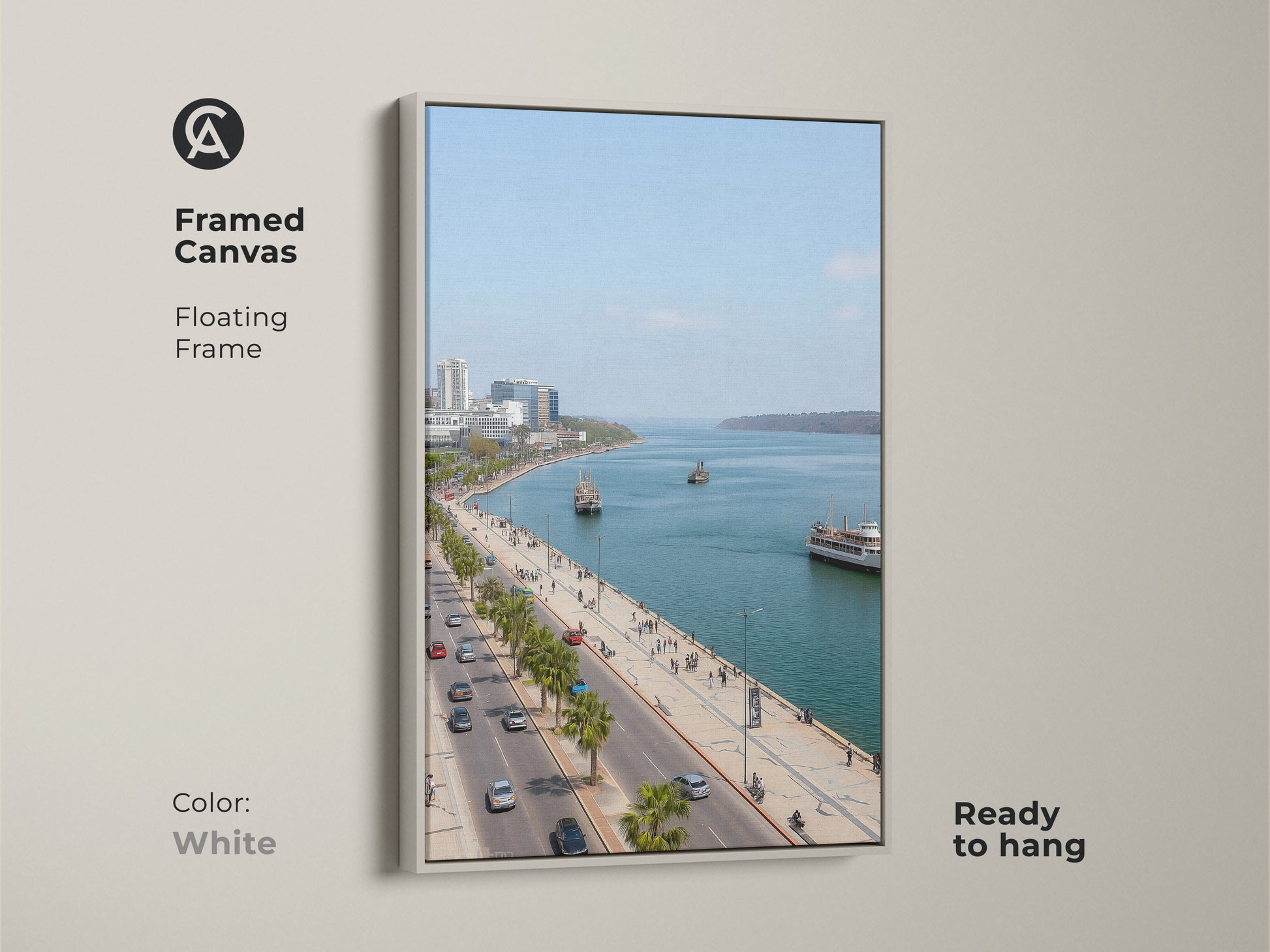 Framed canvas artwork featuring a blue teal coastal cityscape. The white floating frame enhances the travel photography. Palm trees line the street. Perfect for entry hall decor. Contemporary seaside art.