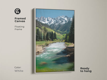 Framed canvas art with a white floating frame. Realistic mountain river landscape artwork with snowy peaks and teal blue water. This ready to hang piece brings a serene rustic nature to your home.