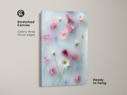 Stretched canvas of soft focus pink daisy and cosmos flowers botanical art. This dreamy floral wall art is ready to hang. The pastel blue artwork features mirror edges. It's a perfect piece of Scandinavian home decor for a tranquil and romantic atmosphere.