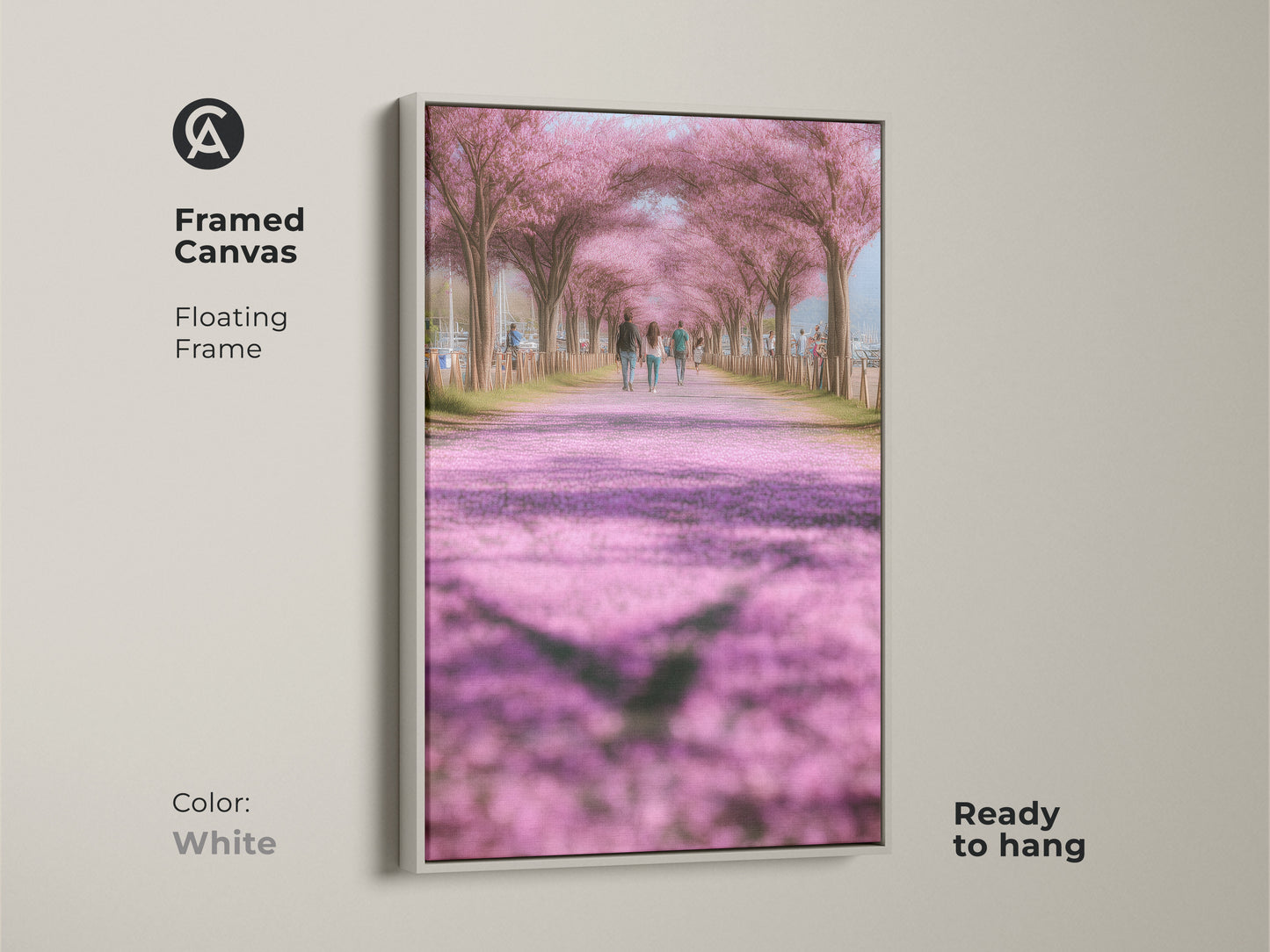 White framed canvas art print of a cherry blossom lined path. Ready to hang this artwork brings a romantic spring feel to your decor. The soft pink and green hues create a calming atmosphere. Suitable for modern farmhouse style. Makes a thoughtful gift for nature lovers.