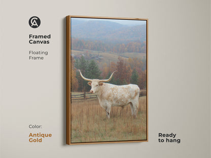 Framed canvas art featuring a Longhorn in a field. The canvas has a floating antique gold frame. Ready to hang in any room. The artwork features a majestic Longhorn in a picturesque fall landscape with snow.
