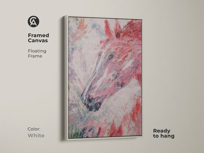 Framed canvas print featuring an abstract horse head with a floating white frame. This modern equestrian art piece offers a clean contemporary look. The canvas showcases pink red and white brush strokes. It is ready to hang. It makes a perfect addition to a bedroom or living area.