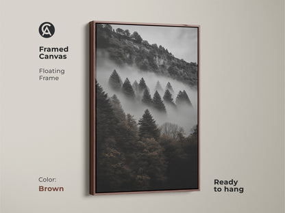 Brown framed canvas showing a dark green forest. Floating frame monochrome mountain wall art. Pine trees in a foggy landscape create depth. Ready to hang modern nature art. This atmospheric forest canvas is perfect woodland canvas decor.
