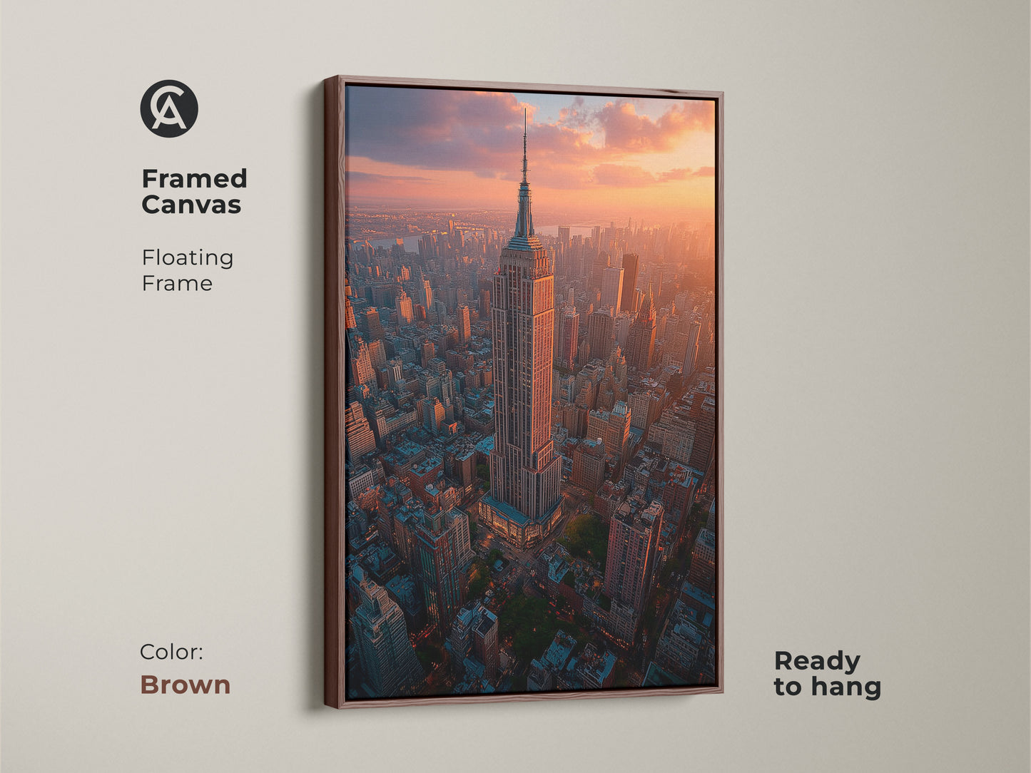 A brown framed canvas showcases an aerial golden hour view of the Empire State Building and New York City. This ready to hang artwork combines cityscape elements with sunset tones. Ideal for adding sophisticated urban photography to your home decor