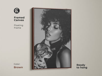 Brown framed canvas art featuring a black and white portrait of a woman and a Bengal cat. The floating frame enhances its contemporary appeal. Ready to hang for easy wall decor. A sophisticated addition to your home.