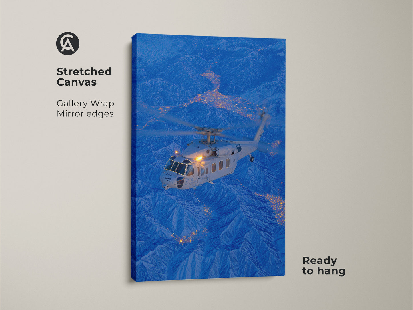 A helicopter flies above a city nestled in the mountains in this stunning stretched canvas. This gallery wrapped artwork features mirrored edges. It is ready to hang and will add depth and dimension to your wall decor.