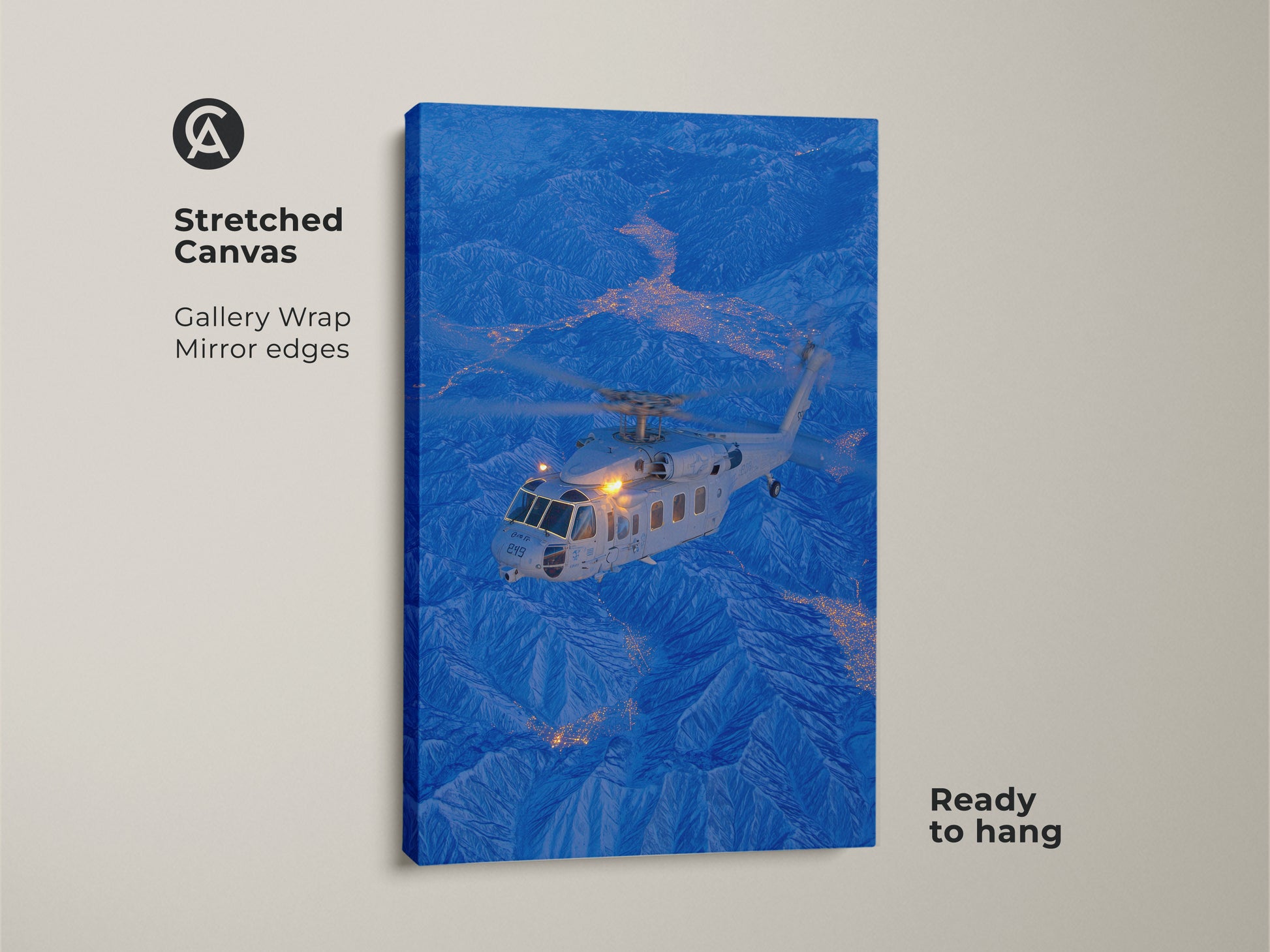 A helicopter flies above a city nestled in the mountains in this stunning stretched canvas. This gallery wrapped artwork features mirrored edges. It is ready to hang and will add depth and dimension to your wall decor.