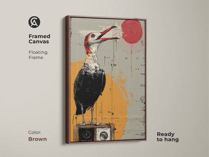 A framed canvas with a brown floating frame features surreal bird artwork. This eclectic piece shows a bird perched on a vintage radio. The red yellow grey palette enhances any space. Perfect for art collectors or as a housewarming gift it adds retro charm to a study or office. It is ready to hang for immediate display.
