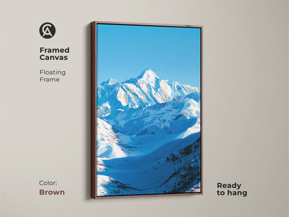 A framed canvas features a floating frame in brown displaying a serene snowy mountain landscape. This ready-to-hang nature artwork is ideal for adding alpine scenery to your space. The blue sky mountain art makes a thoughtful housewarming gift for outdoor enthusiasts. It is a stunning piece of minimalist landscape art.
