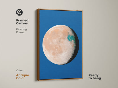 Framed canvas showcasing abstract planet artwork in an antique gold frame. The celestial moon decor is set against a vibrant blue backdrop. This orange teal space wall art has a surreal minimalist style. Ready to hang art.