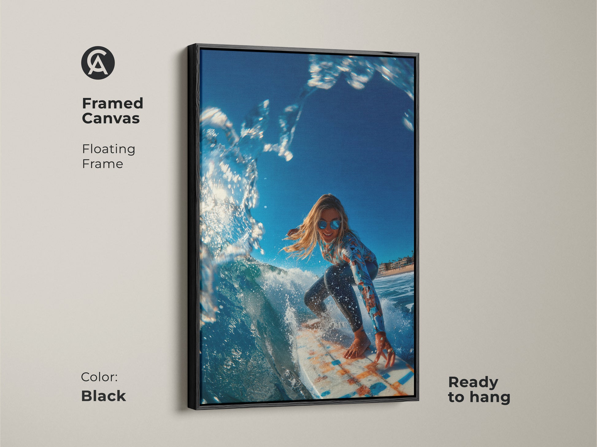 Black framed canvas artwork of a surfer girl riding a wave. The frame is a floating frame. This framed art is ready to hang. The surfer is wearing sunglasses and a long-sleeve swimsuit.