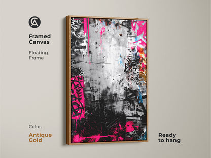 Framed canvas with a floating frame showcasing graffiti artwork in an antique gold frame. The monochrome art is accented by bold pink. Ready to hang adding a touch of urban sophistication to any room.