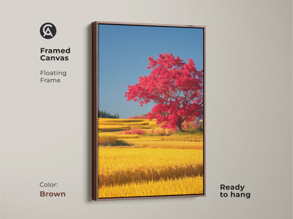 Framed canvas displaying a red tree in a yellow rice field with a brown floating frame. The vibrant nature landscape artwork is ready to hang and brings color to any space. This eclectic home decor art is perfect as a housewarming gift for those who appreciate countryside paintings.