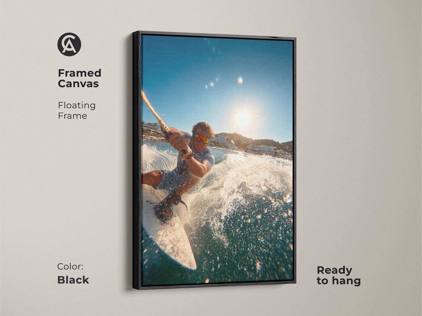 A framed canvas showcases a man wakeboarding. It has a floating frame in black. The artwork is ready to hang. This piece brings a modern touch to any space. It captures the energy and motion of water sports.