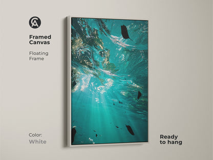 Framed canvas with a floating white frame featuring underwater ocean artwork. The teal and aqua hues enhance this coastal wall decor. This piece is perfect as a gift for beach lovers and adds naturalistic beauty.