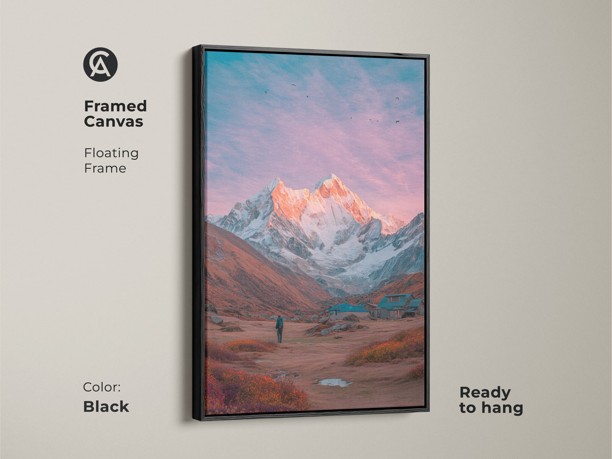 Black framed canvas art of a mountain scene. A snow-covered peak is illuminated by a warm glow. This floating frame adds a touch of elegance. Ready to hang and enjoy. A perfect piece of mountain artwork to complement your decor.