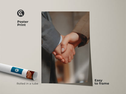 Poster print of handshake wall art rolled in a tube. Easy to frame. This business partnership artwork is a symbol of corporate success. Perfect for modern office decor. A thoughtful professional gift representing collaboration and achievement. Neutral color palette.