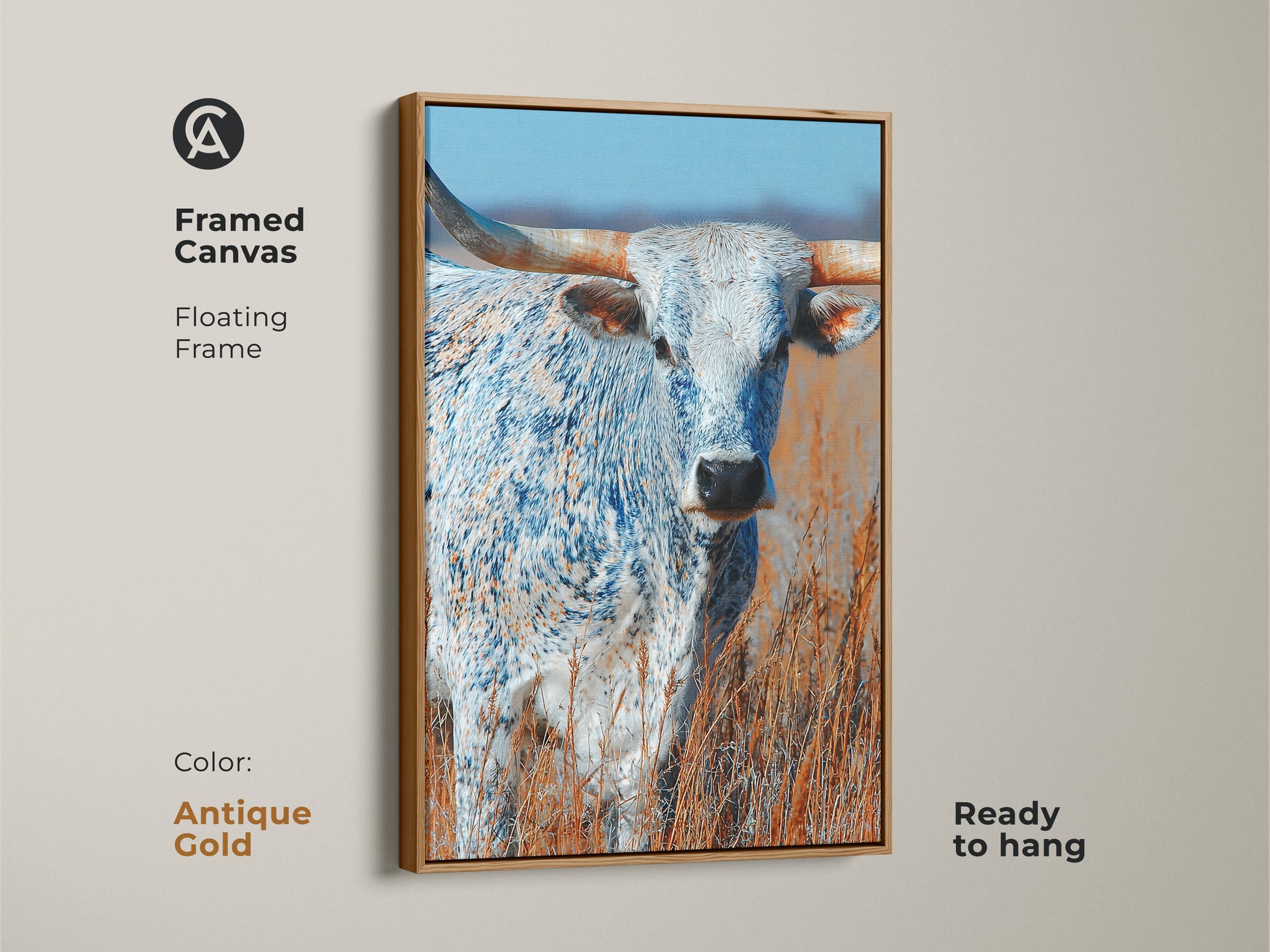 This framed canvas art features a longhorn bull. The artwork has a floating frame. The frame color is antique gold. This canvas print is ready to hang. The animal art is a beautiful addition to any space.