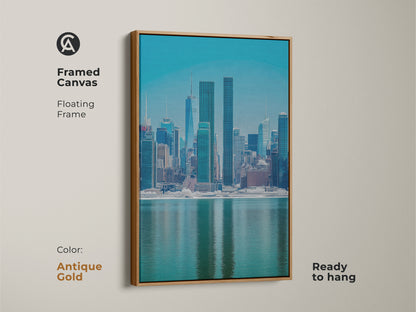 Framed canvas presenting a modern New York City skyline. The antique gold floating frame enhances the blue teal cityscape artwork. This urban waterfront view art is ready to hang. Perfect for contemporary home art and office wall decor.