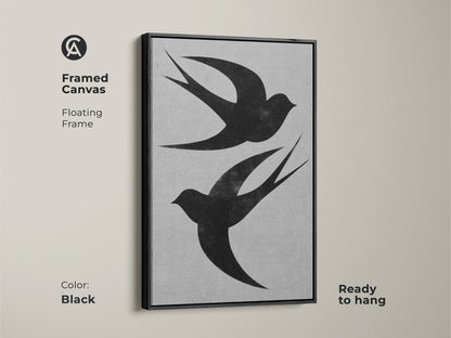 This framed canvas features a floating frame showcasing two black swallows. The minimalist wall art offers a modern nature-inspired aesthetic. Ready to hang this black bird print is perfect for adding elegance to home or office spaces.