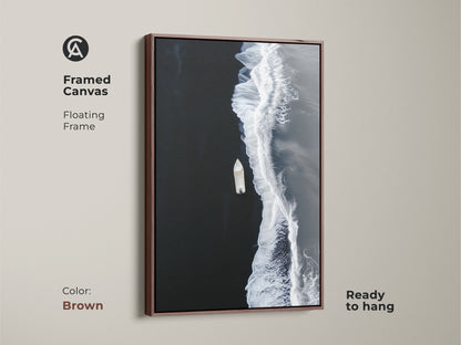 Brown framed canvas of minimalist ocean artwork. A floating frame accents the aerial boat view. Ready to hang coastal beach decor for a modern seascape print.