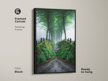 Framed canvas art of a misty forest path with a black floating frame. The emerald green tree-lined road creates a Scandinavian woodland landscape. Ready to hang this nature wall decor brings tranquility to your home. A perfect housewarming gift.