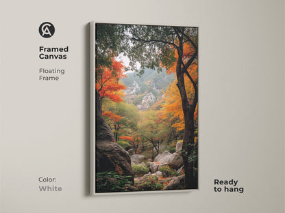 White framed canvas art highlighting an autumn forest landscape. The floating frame offers a clean modern look. This ready-to-hang artwork captures the beauty of fall. The landscape art features colorful trees and rocky terrain. Ideal for minimalist decor.