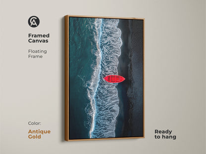 Framed canvas print of a red boat on the beach. The frame is antique gold. Ocean waves crash in this ready to hang artwork. This coastal art will elevate your home decor.