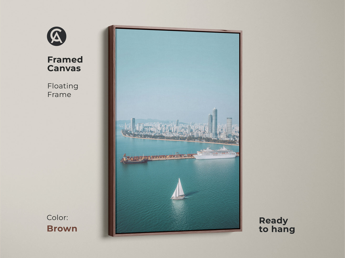 Framed Canvas art with a floating brown frame. Ocean Cityscape Aerial Art Print with a sailboat and cruise ship. Perfect for coastal living room art and nautical home decor.