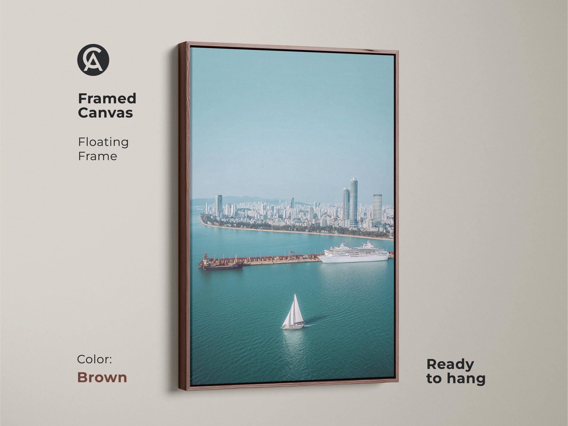 Framed Canvas art with a floating brown frame. Ocean Cityscape Aerial Art Print with a sailboat and cruise ship. Perfect for coastal living room art and nautical home decor.
