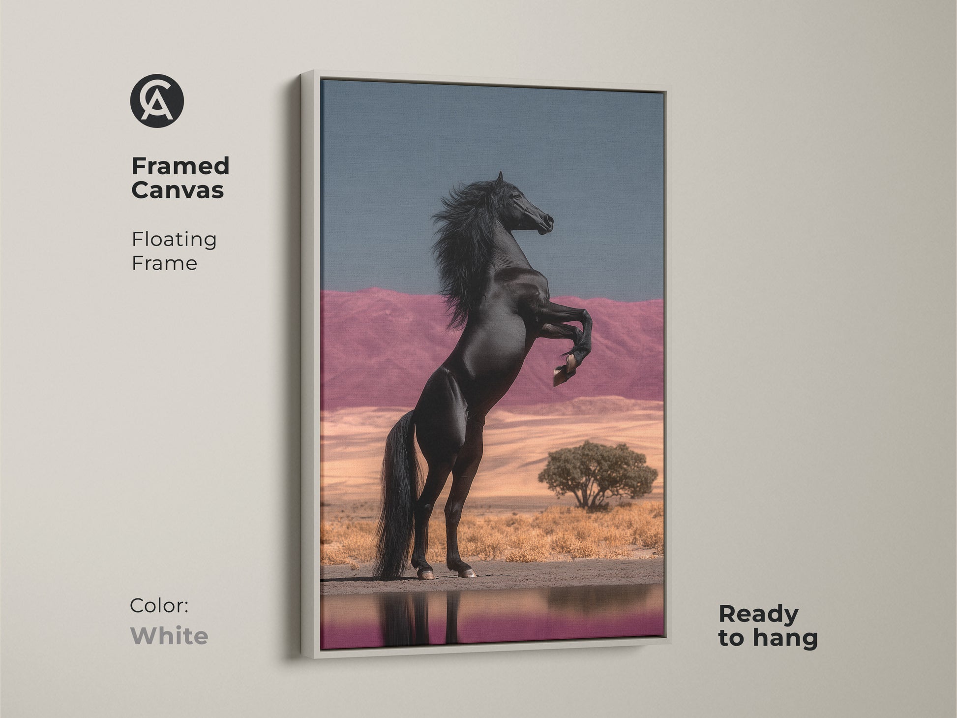 White Framed Canvas with Floating Frame of Black Horse Rearing. This equestrian wall hanging features a powerful stallion against a surreal desert backdrop. The pink mountains and blue sky create an eclectic bedroom artwork. Ready to hang this unique home decor gift is a fine art horse painting. It adds a dramatic flair to any interior.