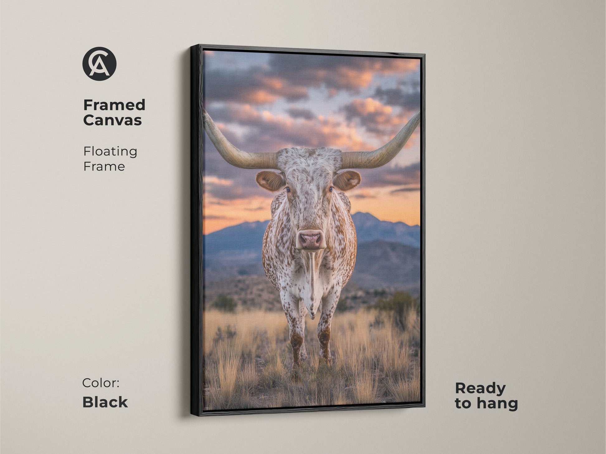 Framed canvas of a longhorn steer with a black floating frame. This rustic western artwork showcases a mountain sunset. This farmhouse landscape art is ready to hang. It's a perfect cowboy gift.