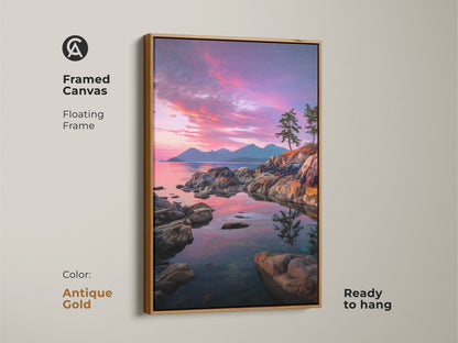 Framed coastal sunset canvas with an antique gold floating frame. The pink purple sky art complements the rocky coastline and pine trees. This ocean view wall decor is ready to hang. Perfect for adding scenic nature prints to your home.
