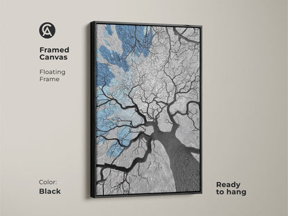 Framed canvas artwork showing an abstract oak tree against a blue sky. The black floating frame adds a touch of elegance. This modern art print enhances any room's decor. The monochrome abstract art complements various interior styles. It’s ready to hang and perfect as a housewarming gift or bedroom wall art.
