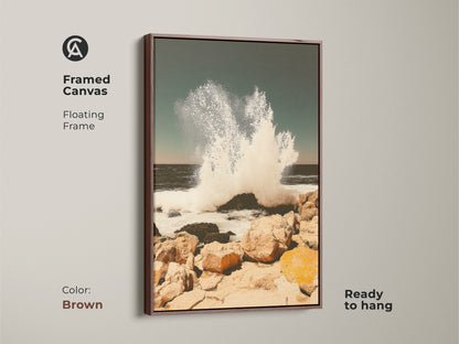 Framed canvas with antique gold frame showcasing teal ocean wave art. Coastal seascape wall art captures a crashing wave on a rocky shore. Ready to hang this beach house canvas art adds coastal living charm providing serene power.