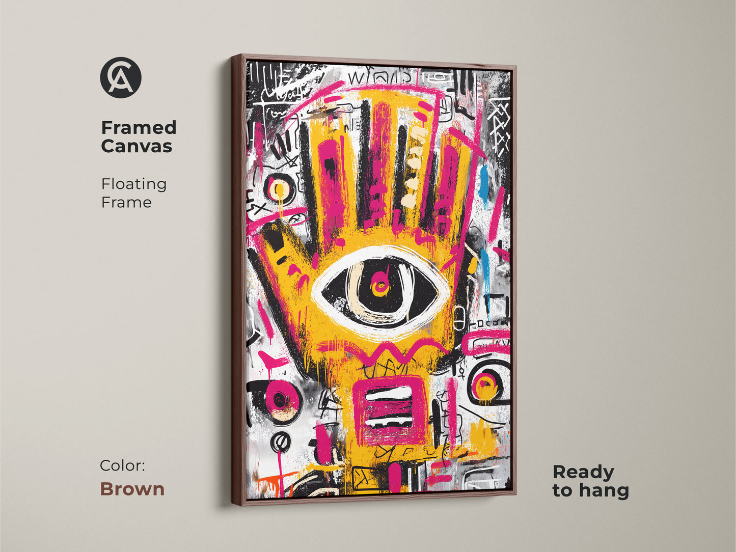 Brown framed canvas of abstract artwork. The floating frame enhances the vibrant yellow and pink hand with an eye. This modern art piece is ready to hang. Perfect for adding a pop of color.