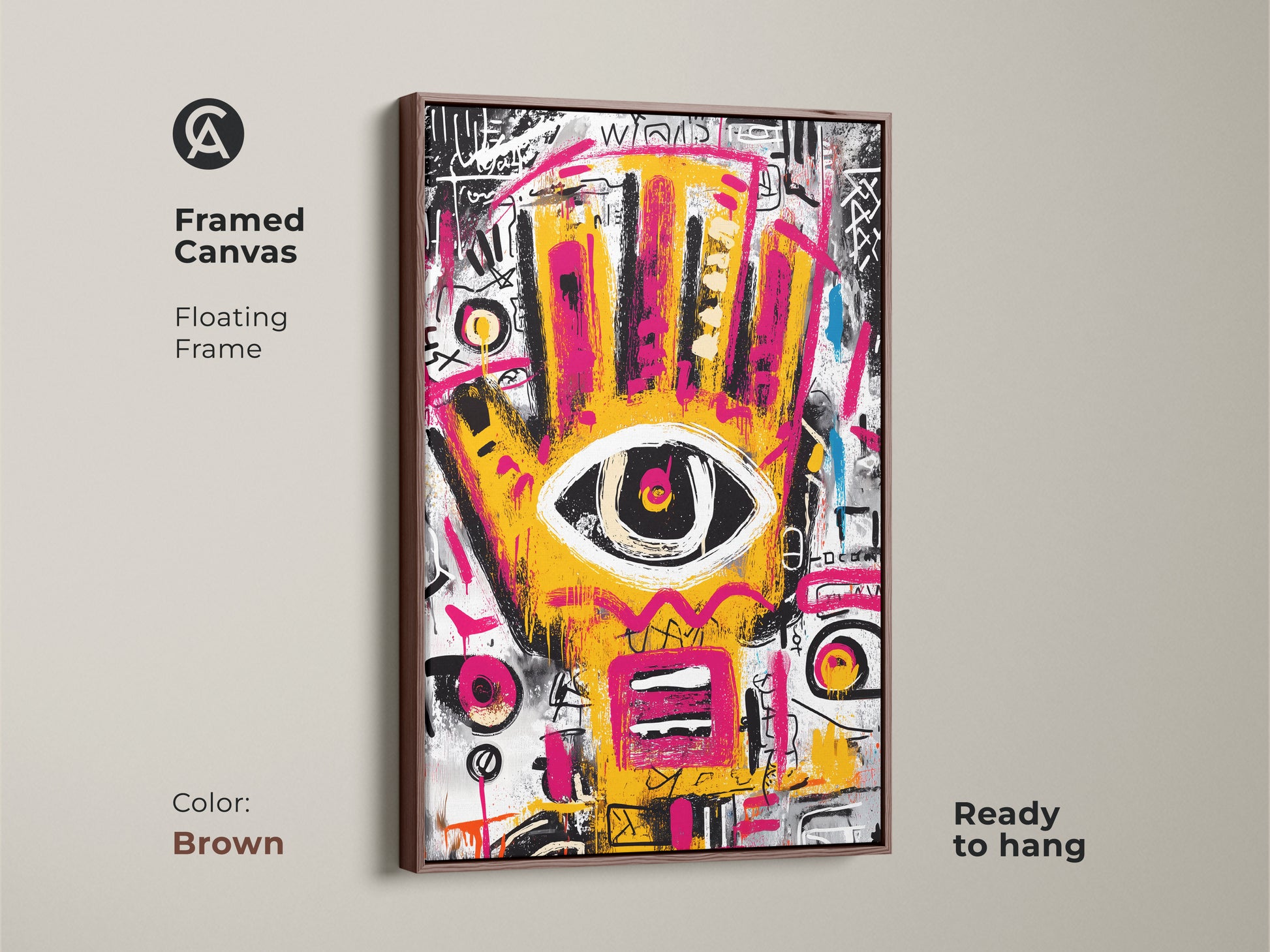 Brown framed canvas of abstract artwork. The floating frame enhances the vibrant yellow and pink hand with an eye. This modern art piece is ready to hang. Perfect for adding a pop of color.