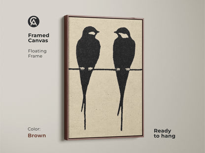 Framed canvas featuring minimalist bird artwork in a brown floating frame. The modern abstract animal art showcases two black bird silhouettes. This black cream art print offers a Scandinavian aesthetic. Ready to hang this contemporary artwork is a great gift for home decor. Perfect minimalist bedroom art.