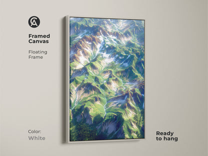 Framed canvas art with a white floating frame. The artwork features an aerial mountain landscape. The canvas is ready to hang. The white frame creates a clean and modern look. Transform your living space with this stunning piece. Perfect for any room.